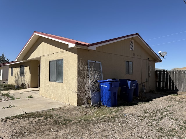 view of home's exterior featuring fence and a patio