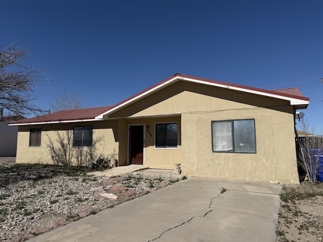 view of front of property with a patio area and metal roof