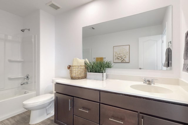 bathroom with shower / bathtub combination, visible vents, toilet, vanity, and wood finished floors