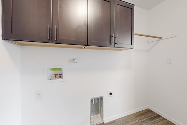 laundry room featuring cabinet space, baseboards, wood finished floors, hookup for an electric dryer, and washer hookup