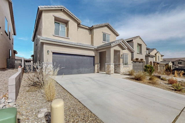 view of front of house featuring stucco siding, an attached garage, fence, stone siding, and driveway