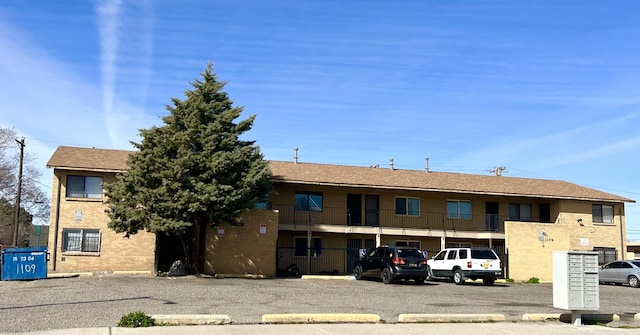 view of building exterior featuring uncovered parking