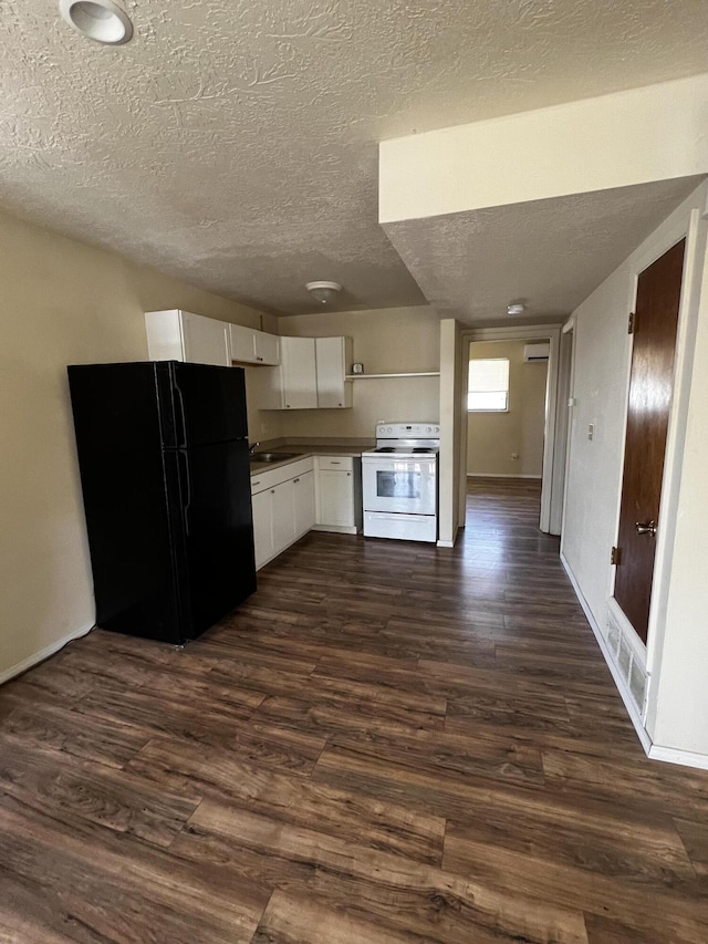 kitchen with freestanding refrigerator, dark wood-style flooring, white electric range oven, and white cabinetry