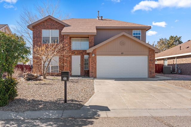 traditional home with an attached garage, cooling unit, concrete driveway, and brick siding