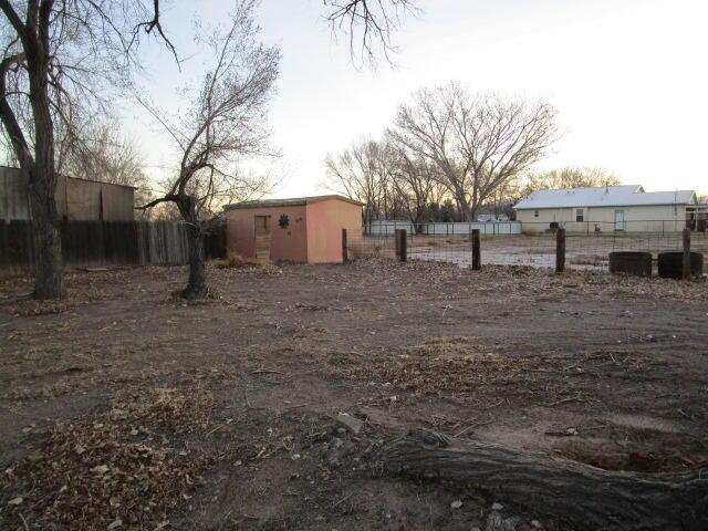 view of yard featuring an outbuilding and fence