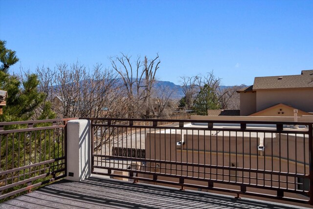 wooden deck featuring a gate and a mountain view