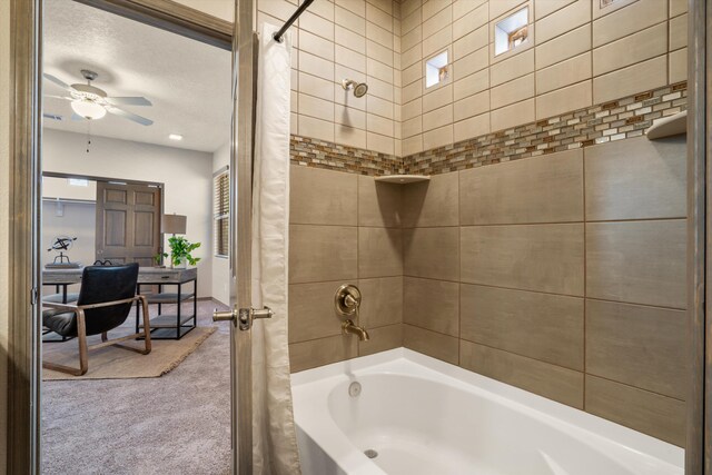 bathroom with ceiling fan, a textured ceiling, and shower / bath combo