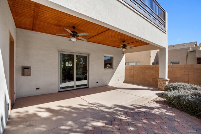 view of patio featuring fence and a ceiling fan