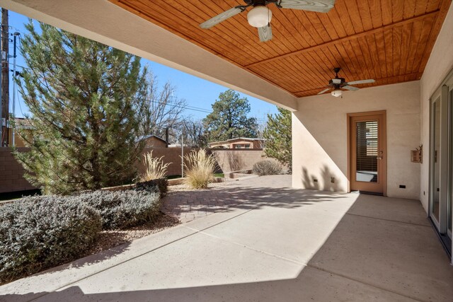 view of patio featuring fence and ceiling fan