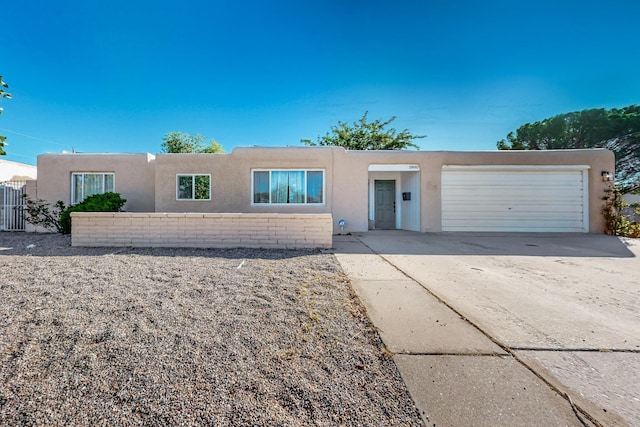 view of front of home featuring a garage, driveway, and stucco siding