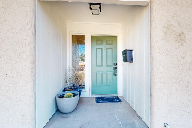 doorway to property featuring stucco siding