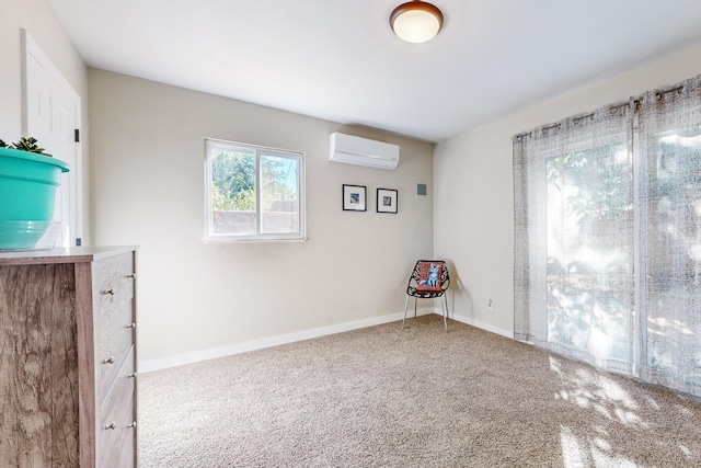 carpeted spare room featuring an AC wall unit and baseboards