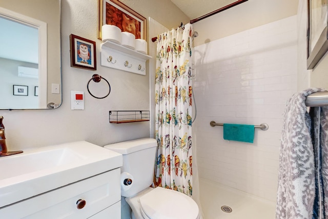 bathroom featuring vanity, a shower stall, and toilet