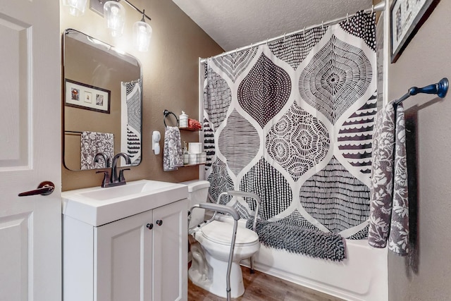 full bathroom with a textured wall, toilet, a textured ceiling, vanity, and wood finished floors