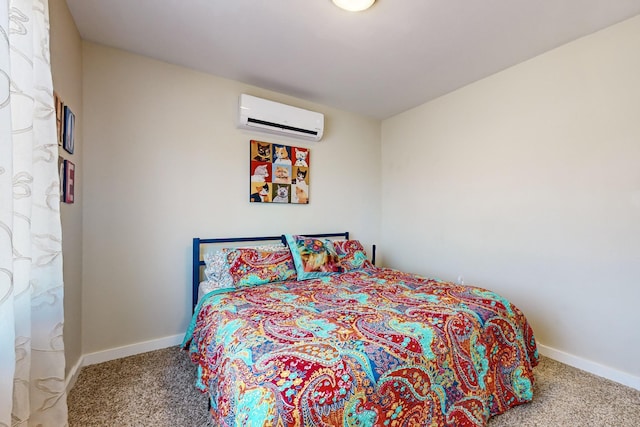 bedroom with a wall mounted air conditioner, carpet flooring, and baseboards