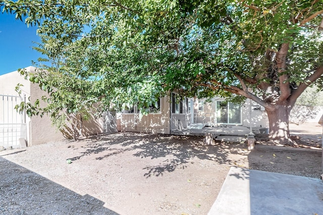 obstructed view of property with a patio area and fence