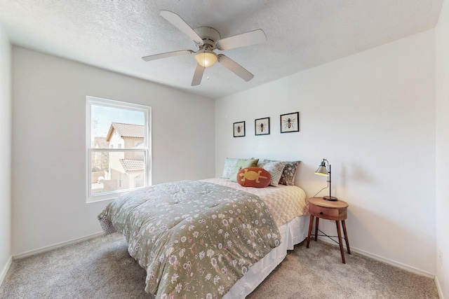 bedroom featuring a textured ceiling, baseboards, and carpet floors