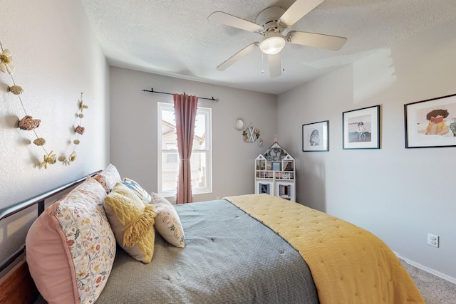 carpeted bedroom with a ceiling fan, baseboards, and a textured ceiling