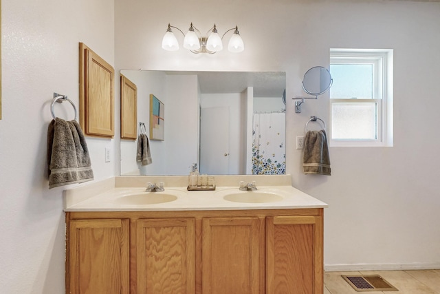 bathroom featuring a sink, visible vents, and double vanity