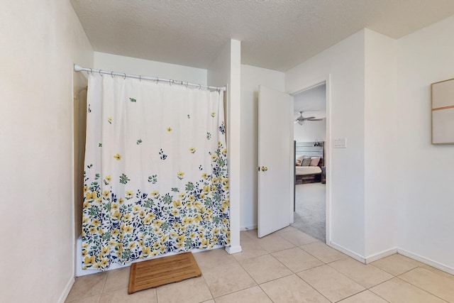 full bath with tile patterned floors, a textured ceiling, ensuite bath, and a shower with curtain