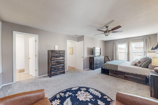 carpeted bedroom with baseboards, a textured ceiling, and a ceiling fan