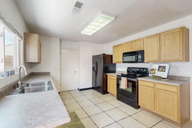 kitchen featuring a sink, visible vents, black appliances, and light brown cabinetry