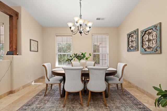 dining space featuring visible vents, baseboards, and an inviting chandelier