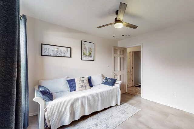 bedroom featuring a ceiling fan and baseboards