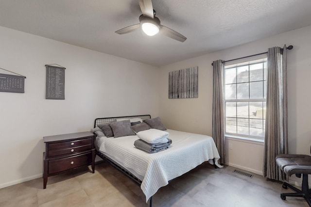 bedroom with a ceiling fan, visible vents, and baseboards