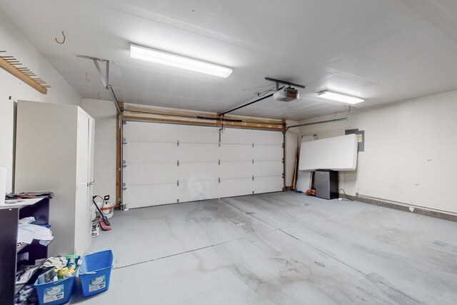 garage with electric panel and a garage door opener