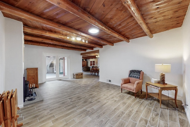 sitting room with wooden ceiling, light wood-style flooring, visible vents, french doors, and beamed ceiling