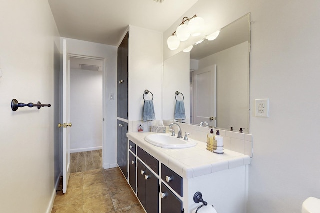 bathroom with vanity and baseboards