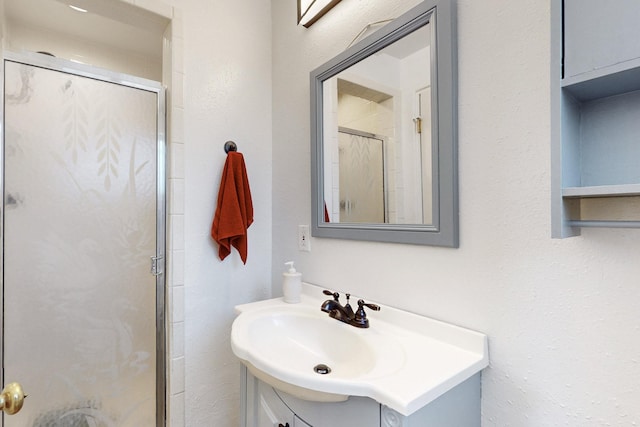 bathroom featuring a stall shower and vanity