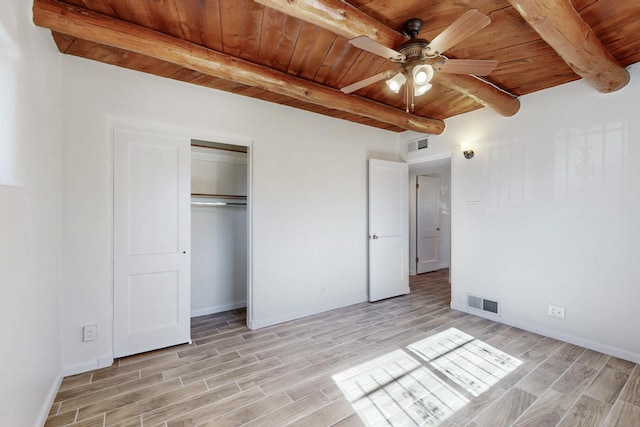 unfurnished bedroom with wood tiled floor, wooden ceiling, visible vents, and beamed ceiling