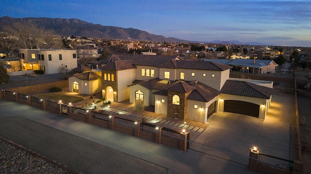 view of front of home with driveway, a fenced front yard, a residential view, a tiled roof, and stucco siding