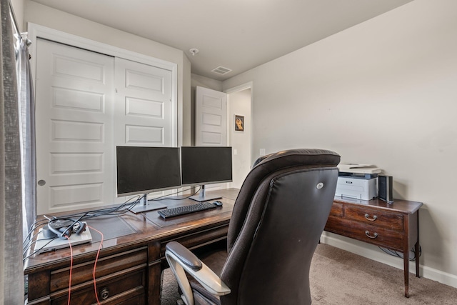 carpeted office featuring visible vents and baseboards