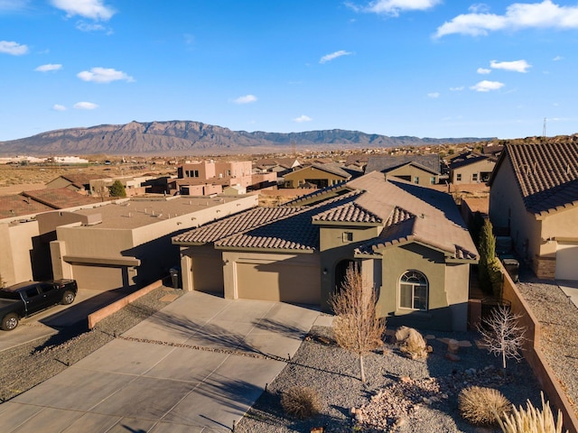 view of front facade with a garage, a residential view, concrete driveway, and stucco siding