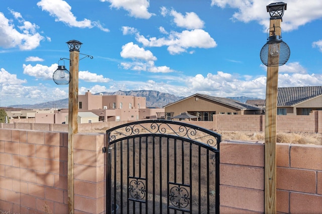 view of gate featuring fence and a mountain view