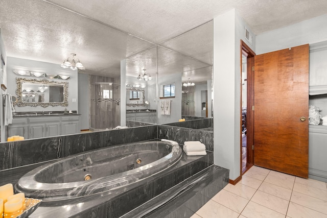 bathroom with an inviting chandelier, a tub with jets, a walk in shower, and a textured ceiling