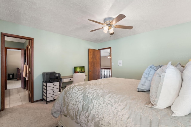 carpeted bedroom featuring a ceiling fan, a textured ceiling, and tile patterned floors