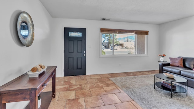 entryway with baseboards and visible vents