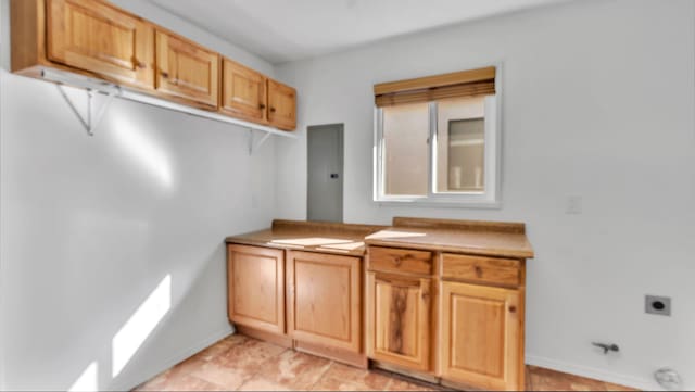 laundry room featuring baseboards and hookup for an electric dryer