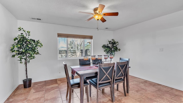 dining area with visible vents, ceiling fan, a textured ceiling, and baseboards