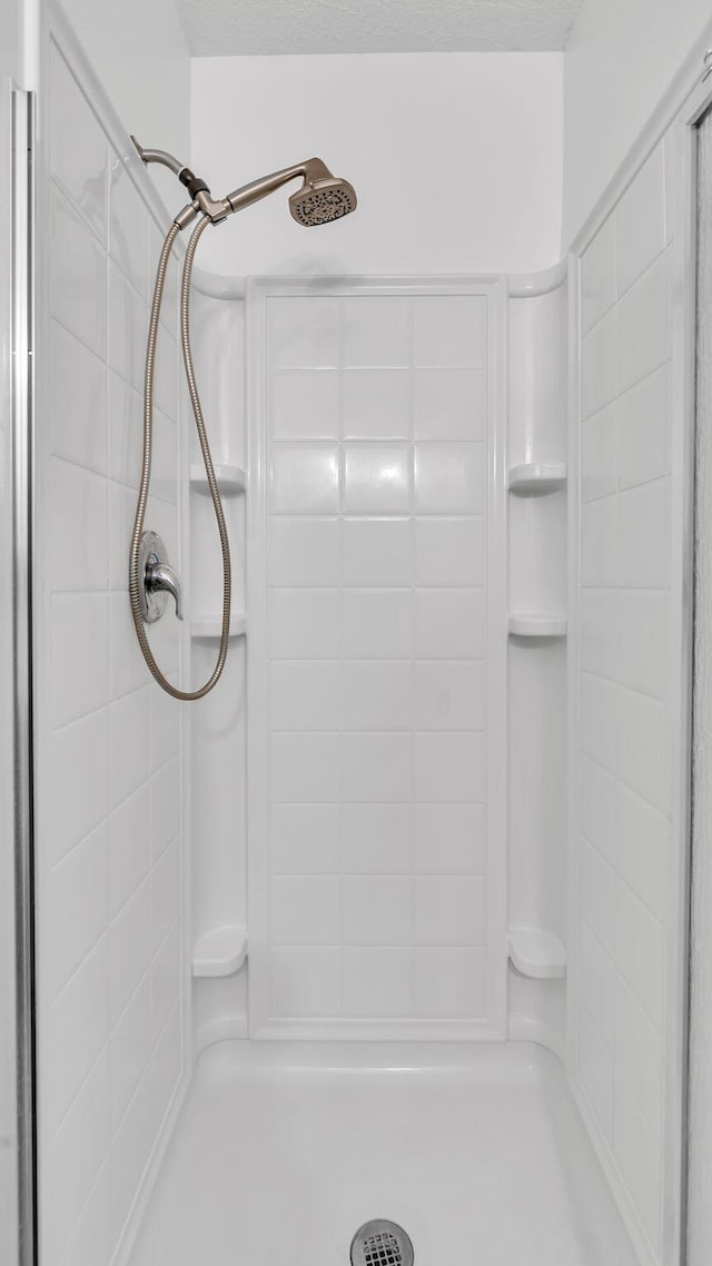 full bath with a tile shower