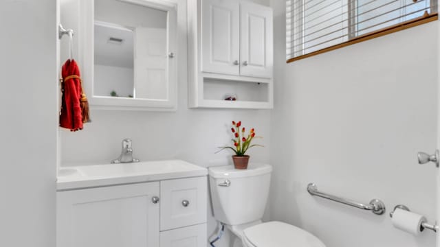 bathroom featuring toilet and vanity