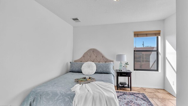 bedroom featuring visible vents and a textured ceiling