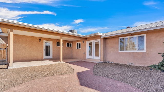 exterior space with french doors, a patio area, and stucco siding