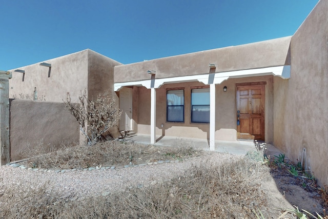 doorway to property with stucco siding