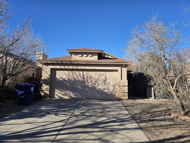 view of property exterior featuring an attached garage, driveway, a chimney, and stucco siding