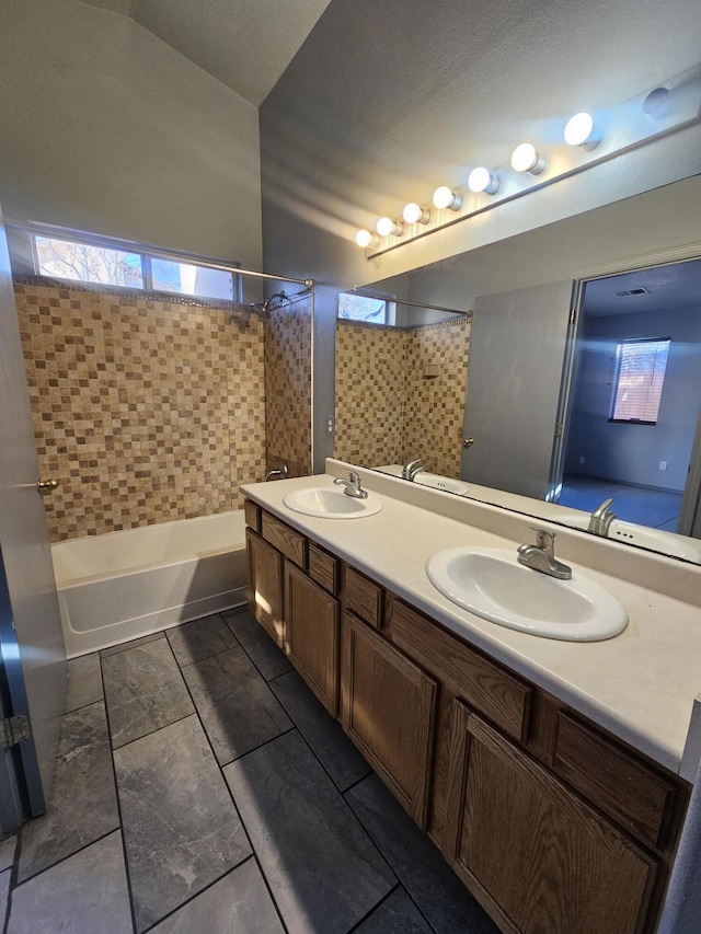 full bathroom featuring double vanity, a sink, and washtub / shower combination